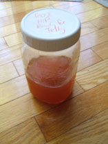 Jar of rosehip juice ready for jelly making.