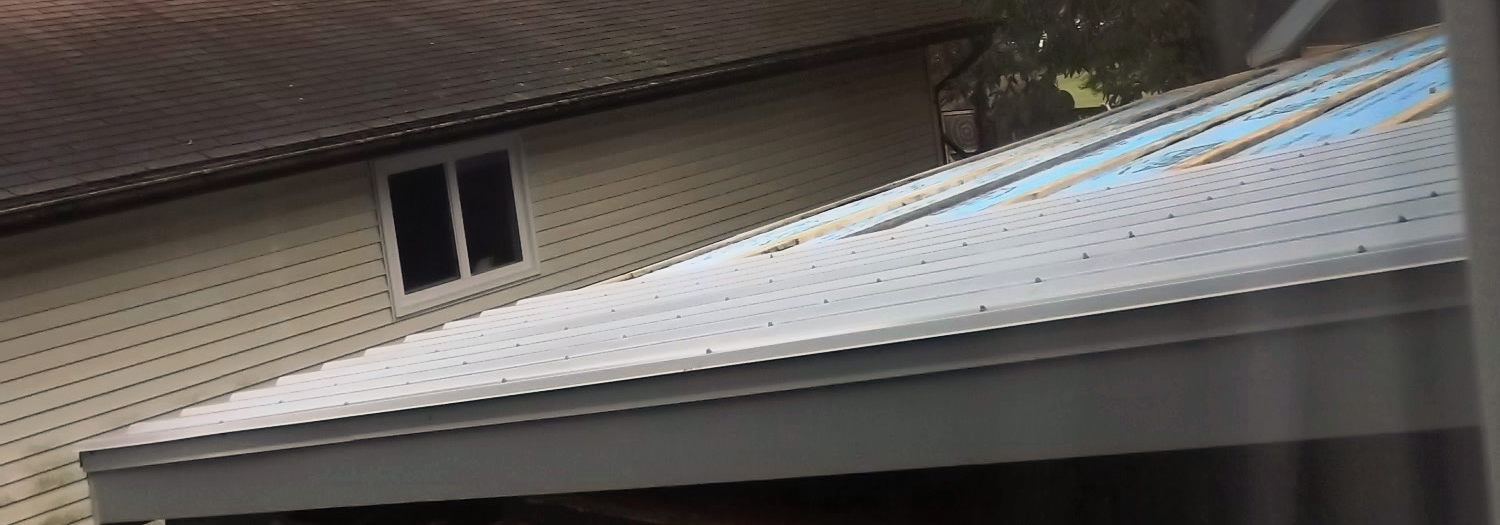 Two metal roof panels installed.
