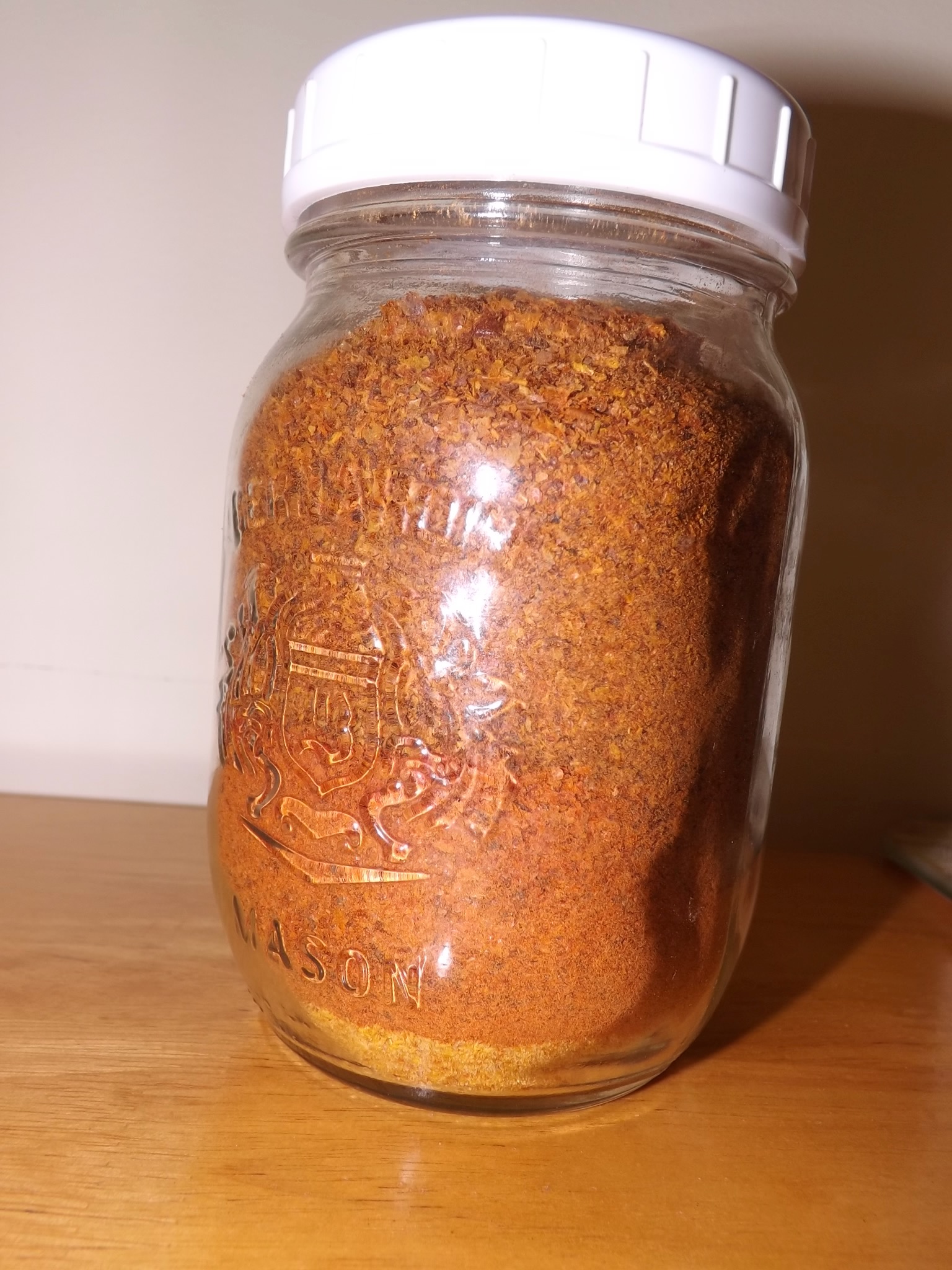 Jar of powdered tomatoes, with three layers.