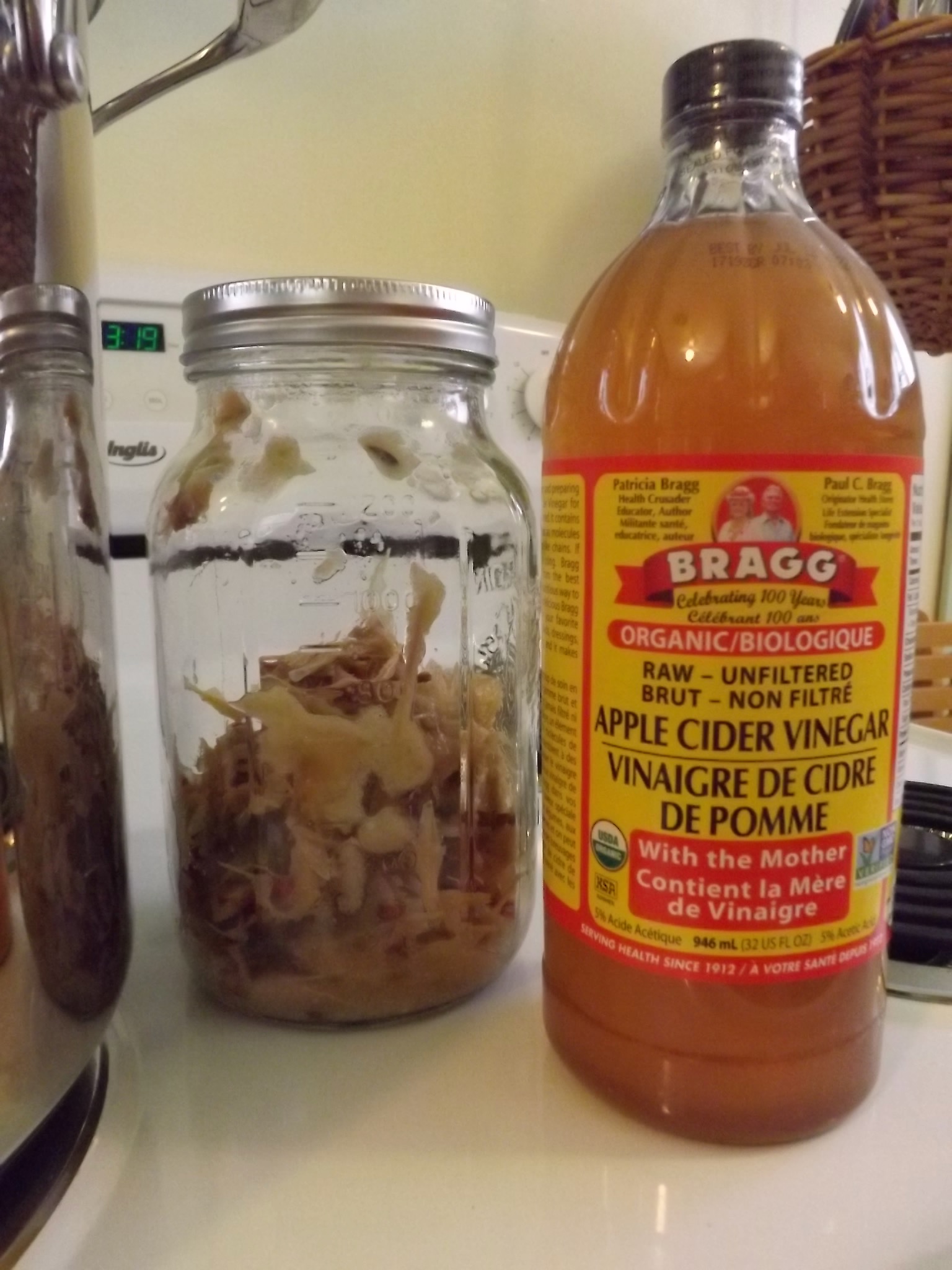 jar with apple skins and seeds and botto of apple cider vinegar