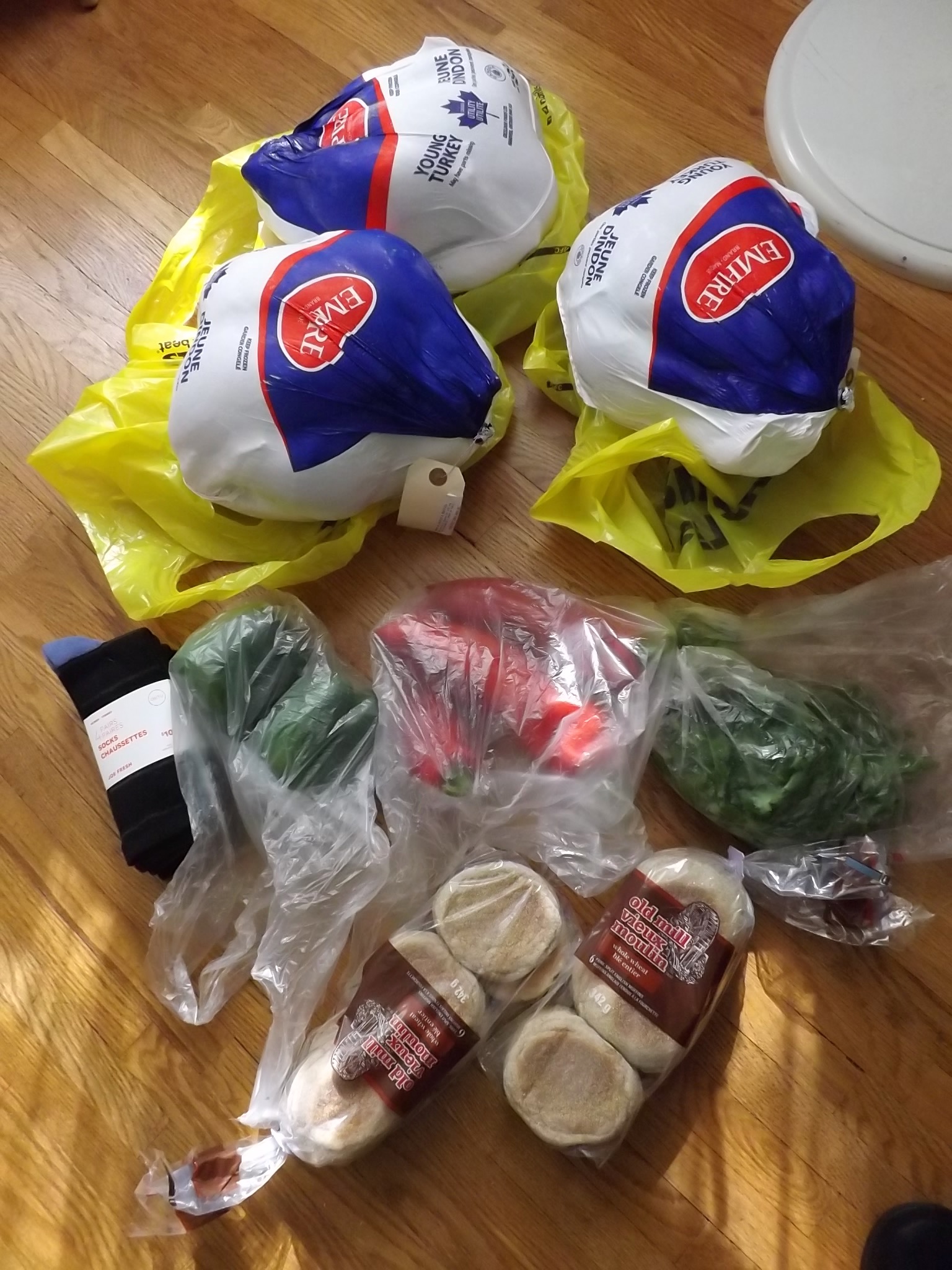 groceries with total cost of 95 cents, includes 3 frozen turkeys, socks, green peppers, red peppers cilantro and two packages of English Muffins.