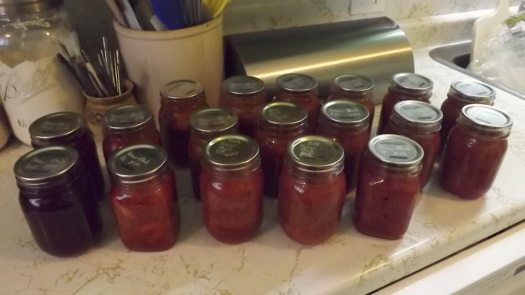 Canning jars of Strawberry Rhubarb Pie Filling and Strawberry Rhubarb Juice.