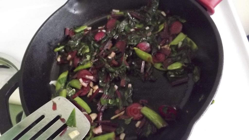 Frying pan with sauteed vegetables.