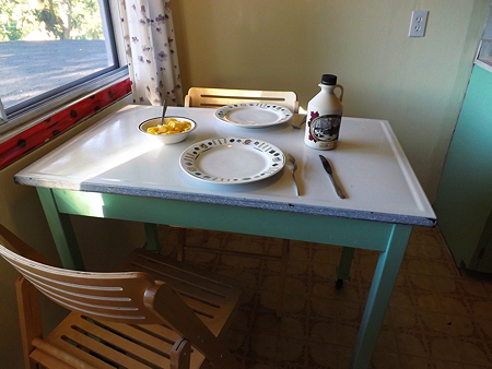 metal top table in front of large dining area window