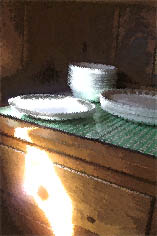 afternoon sun falling on stacked dinnerware