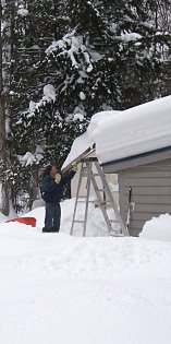 Attila beginning the process of shoveling off the lean-to roof.